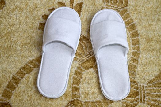 White slippers closeup on floor