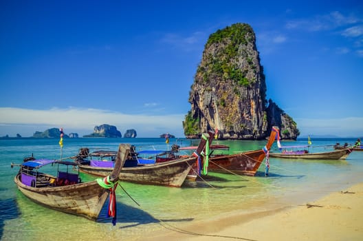 Beautiful tropical ocean beach with long tail boats in Andaman sea, Thailand
