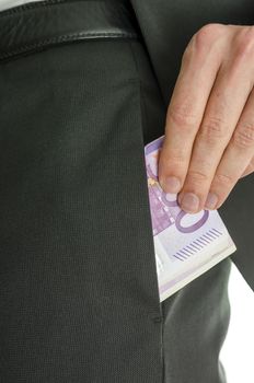 Detail of a male hand putting five hundred Euro banknotes in pocket on  pants of a suit.