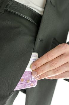 Well dressed man putting 500 Euro banknotes in his pants pocket. Representing concept of bribery.