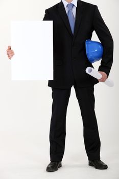 Architect with plans and blank message board