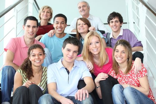 Group of young people sitting on stairs