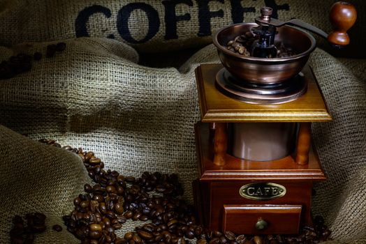 Coffee Mill with beans and burlap. still life