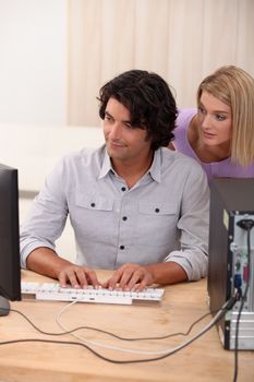 Man helping colleagues with computer issue