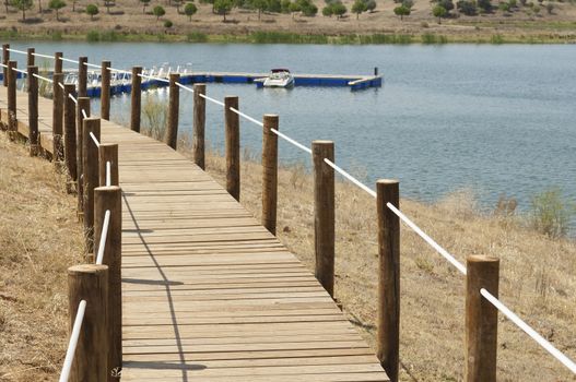 Wooden walkway serving Amieira pier on the banks of the reservoir of Alqueva, Alentejo, Portugal