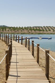 Wooden walkway serving Amieira pier on the banks of the reservoir of Alqueva, Alentejo, Portugal