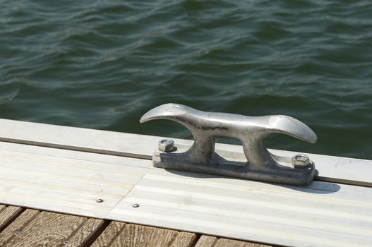 Detail of a wooden floating dock with mooring bitts