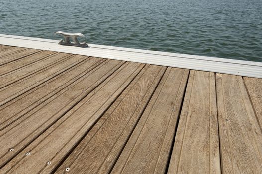 Detail of a wooden floating dock with mooring bitts