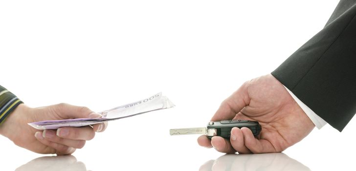 Cropped view of female hand giving money and receiving car keys from seller. Over white background.