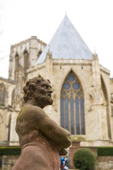 YORK, UK - MARCH 30: Statue at the Treasurer's House's garden with York Minster in the background. March 30, 2013 in York.