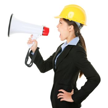 Megaphone screaming engineer contractor business woman with hard hat yelling angry, mad and upset in profile. Funny image of multicultural young professional isolated on white background in studio.