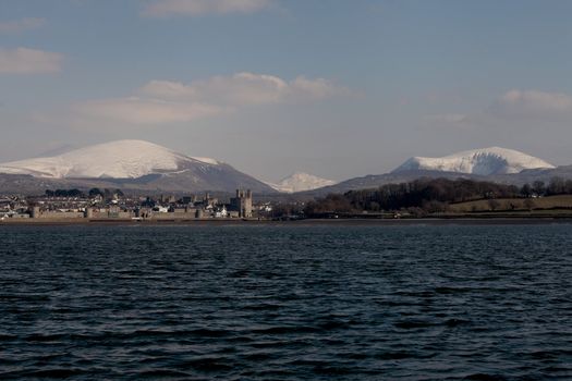 Medievil Caernarfon castle and town with Snowdonia as a back drop in north Wales 