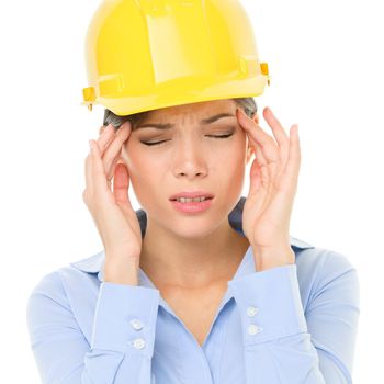 Engineer or architect woman worker having headache migraine stress wearing yellow hard hat. Young female mixed race Caucasian / Asian Chinese professional isolated on white background