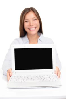 Laptop computer - woman showing screen smiling happy. Focus on pc display for copy space text or design. Beautiful happy multicultural Asian Caucasian female model isolated on white background.