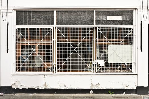 A store protected by window metal bars in a town