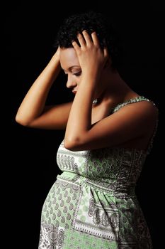 Depression and stress of young pregnant woman against black background