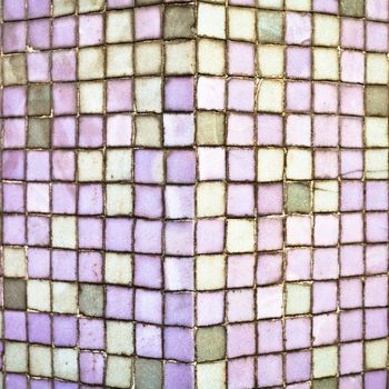 Purple tiles on the corner of a wall