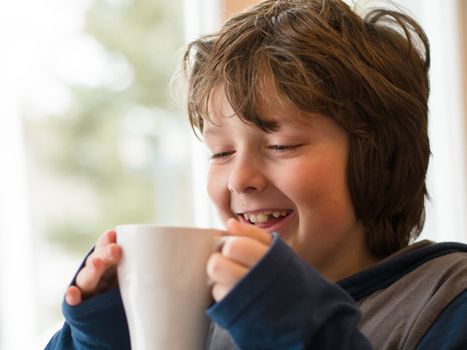 Young boy drinking a hot chocolate