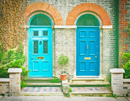 Pair of blue front doors of victorian houses in the UK
