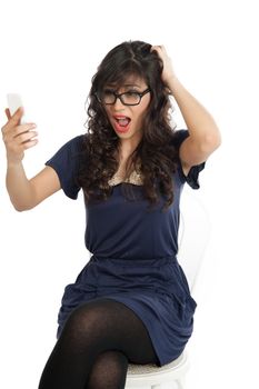 Woman in glasses emotionally speaks on a mobile phone