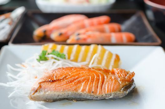 fish steak and fresh vegetable on white plate