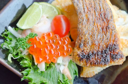 top view of  fish egg with salad and  grilled cod fish