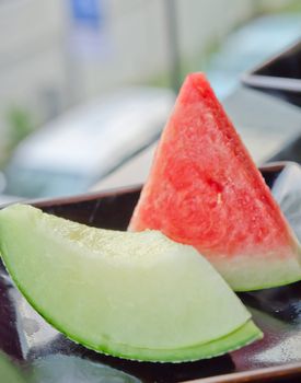 cantaloupe melon slices and red watermelon  on dish