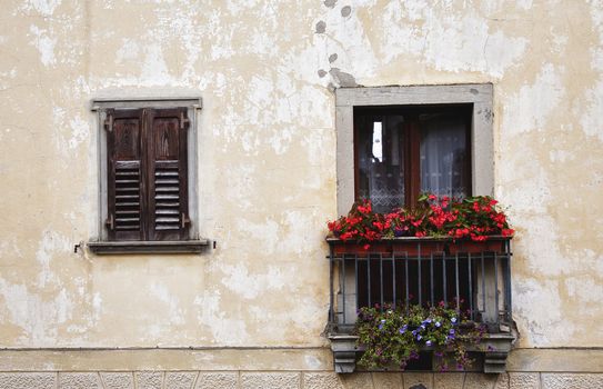 Tiny Italian balcony with flowers at summertime.