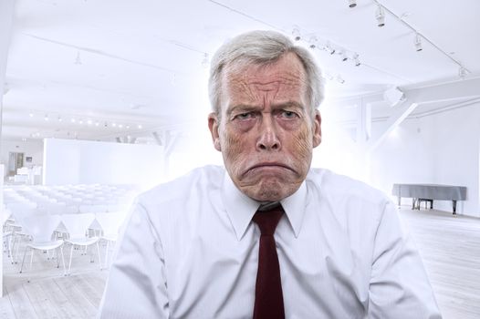 Upset depressed Caucasian businessman with huge frown and mouth curved down at corners, portrait