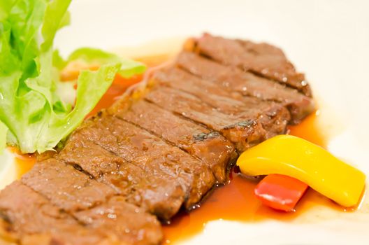 close up roasted beef fillet on  plate served with vegetable