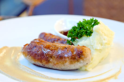 grilled sausage and  mashed potato on dish