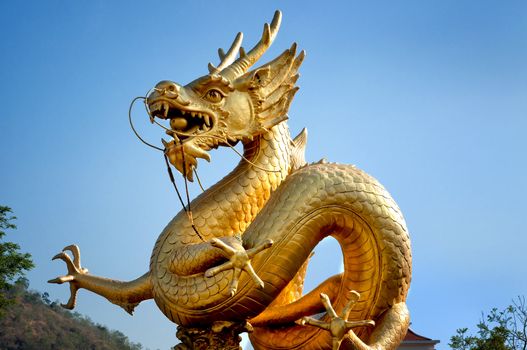 Golden dragon over blue sky. Phuket, Thailand