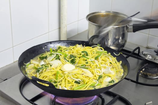 Hokkien Mee Stir Fry Yellow Noodles Cooking in Wok on Gas Fire Stove Top