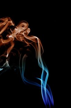 wave and smoke of different colors on black background