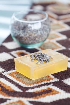 lavender in bowl and soap on ethnic mat