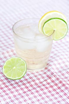 water with lemon and lime in a glass with ice