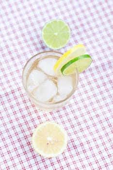 water with lemon and lime in a glass with ice