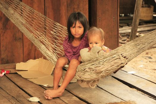 Kids sitting in a hammock, Koh Rong Samlon island, Cambodia, Southeast Asia