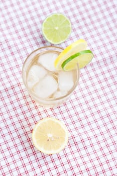 water with lemon and lime in a glass with ice