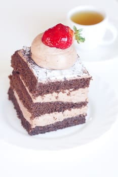 beautiful cake with strawberry and tea on a white background