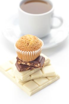 bar of chocolate,tea and muffin isolated on white