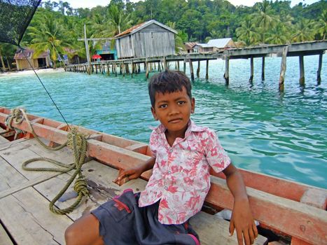 Young boy sitting in a boat, Koh Rong island, Cambodia, Southeast Asia