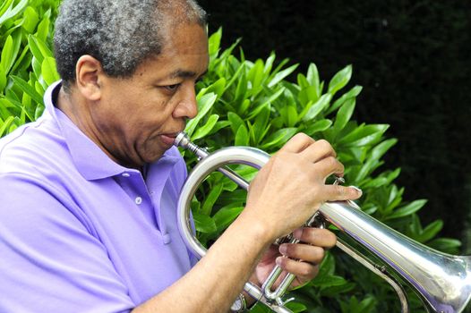 African American man with his flugelhorn.