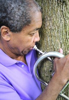 African American man with his flugelhorn.