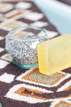 lavender in bowl and soap on ethnic mat