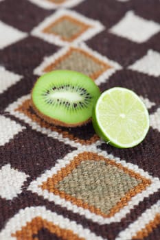 kiwi and lime on ethnic mat