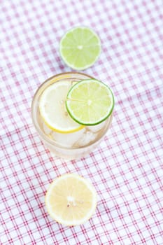 water with lemon and lime in a glass with ice