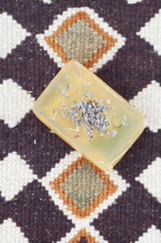 lavender and soap on ethnic mat