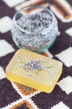 lavender in bowl and soap on ethnic mat