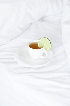 bed with a pillow and a cup of tea 